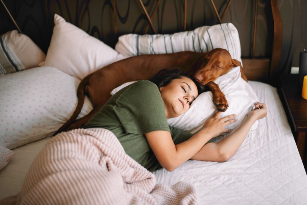 A young lady sleeping with her dog at our sober living apartments.